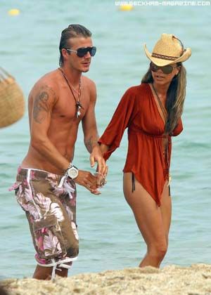 Victoria and David Beckham wearing swimming clothes at the seasite