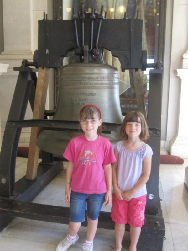 Emma and Jenna in front of the Pass & Stow bell